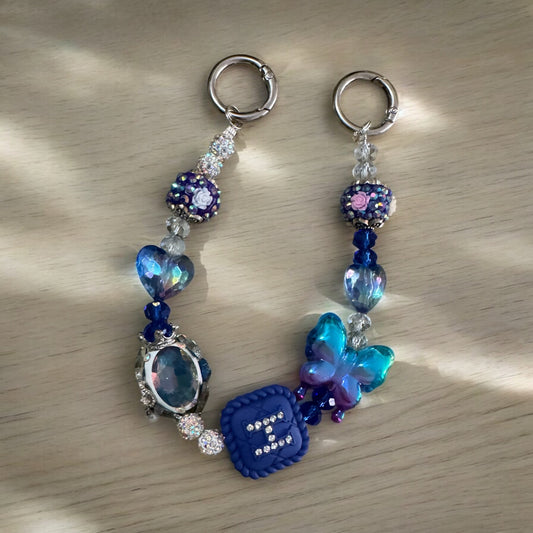 Llavero de pulsera con cuentas y mariposa brillante